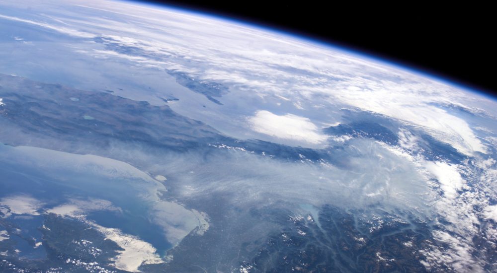 September 6, 2006 - Haze in the Po River Valley of Italy is featured in this image photographed by an Expedition 13 crewmember onboard the International Space Station. The valley is visible across the horizontal center of the frame, with the floor obscured by what NASA scientists refer to as frequent atmospheric haze, a mixture of industrial pollutants, dust and smoke. The visual texture of such haze is perceptibly different from that of bright white clouds which stretch across the top of the scene and cover part of the Alps. Northern Italy is in the foreground of this southwesterly view. The partially cloud-covered Alps are at lower right; the Adriatic Sea at lower left. Corsica is under partial cloud cover at center; and Sardinia, almost totally obscured, is to its south. The island of Elba is visible just to the west of Italy. By contrast with haze accumulation along the axis of the valley, the Alps and the Apennines are clearly visible, and Lake Garda can be seen in the foothills of the Alps. Other visible geographic features are the lagoon at Venice north of the Po River delta, and three small lakes north of Rome.