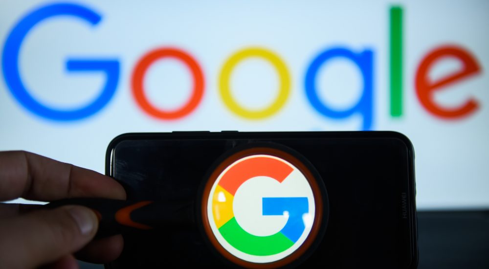 KRAKOW, POLAND - 2018/09/07: Google  logo is seen trough a magnifying glass on an android mobile phone in front of a computer screen  with google sign. (Photo by Omar Marques/SOPA Images/LightRocket via Getty Images)