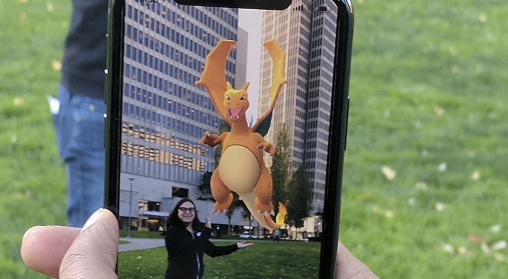 In this Monday, Dec. 18, 2017, photo, Pokemon Go is played at a park in San Francisco. Pokemon Go is unleashing its digital critters in Apple’s playground for augmented reality, turning iPhones made during the past two years into the best place to play the mobile game, according to the CEO of the company that makes Pokemon Go. (AP Photo/Michael Liedtke)