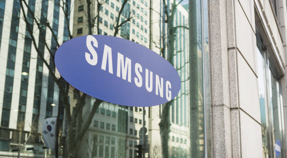 Seoul, Republic of Korea - March 26, 2013: The Samsung logo on the window of one of the South Korean company's offices in Gangnam, central Seoul, with cars and people on the street reflected  in the window.
