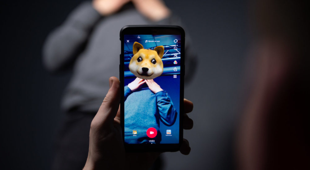 An AFP collaborator poses for a picture using the smart phone application TikTok on December 14, 2018 in Paris. - TikTok, is a Chinese short-form video-sharing app, which has proved wildly popular this year. (Photo by - / AFP)        (Photo credit should read -/AFP/Getty Images)