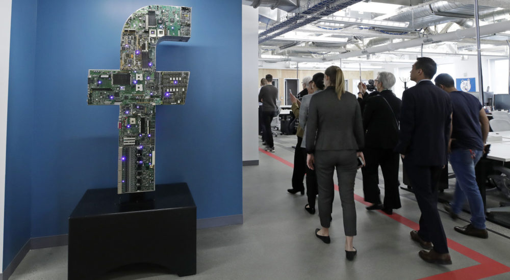In this Jan. 9, 2019 photo, media and guests tour Facebook's new 130,000-square-foot offices, which occupy the top three floors of a 10-story Cambridge, Mass. building. The space gives the company room to triple its current local staff of more than 200. The Silicon Valley company, created by Mark Zuckerberg when he was two subway stops away at Harvard University, opened its first Boston office five years ago. (AP Photo/Elise Amendola)