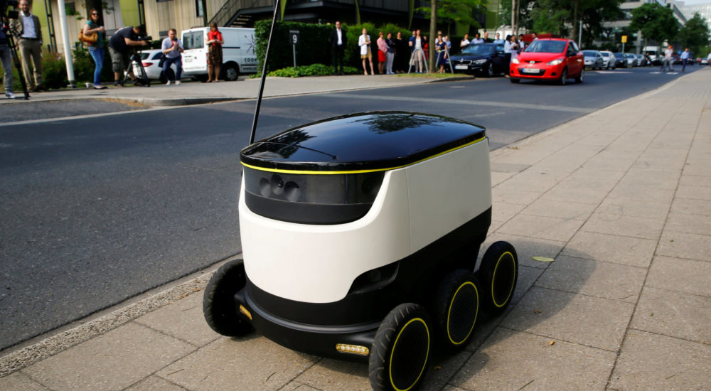 A Starship Technologies commercial delivery robot navigates a pavement during a live demonstration in front of the headquarters of Metro AG in Duesseldorf, Germany, June 7, 2016. REUTERS/Wolfgang Rattay/File Photo