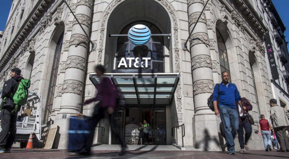 Pedestrians walk past the AT&T Corp. west coast flagship store in San Francisco, California, U.S., on Wednesday, Sept. 28, 2016. AT&T Corp. spent in excess of $10 million over a course of 2 years to renovate, rebuild and connect the 20,000 square foot space in the 108 year old building into the company's largest store in the country. Photographer: David Paul Morris/Bloomberg via Getty Images
