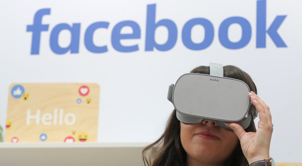 A woman uses an Oculus virtual reality headset at the Facebook stand during the Dublin Tech Summit, held at the Royal Dublin Society (RDS) in Dublin, Ireland.