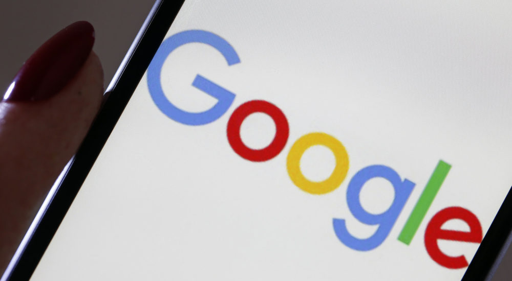 PARIS, FRANCE - MARCH 20: In this photo illustration, the Google logo is displayed on the screen of an iPhone on March 20, 2019 in Paris, France. Today, the European Commission has punished Google for a fine of 1.49 billion euros for abuse of dominant position in the search and advertising market via its AdSense offer. Google is the most used web search engine in the world. In 2018, 90% of Internet users used it in the world. (Photo by Chesnot/Getty Images)